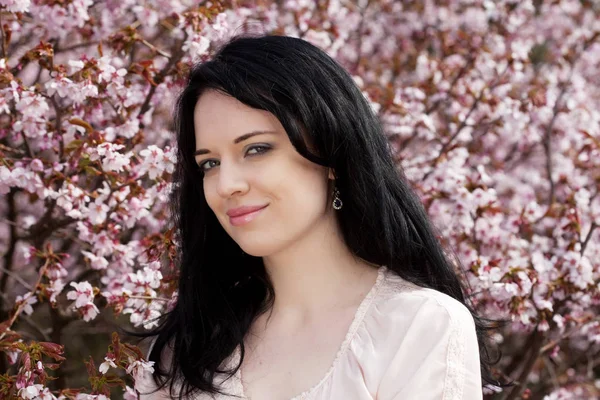 Estilo de vida y el concepto de la gente: Hermosa mujer joven en el jardín de flores —  Fotos de Stock