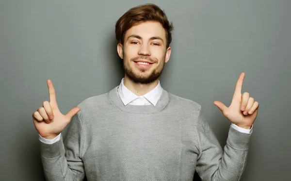 A young and handsome businessman pointing up with his finger — Stock Photo, Image