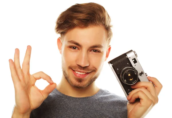 Young man with camera. Isolated over white background. — Stock Photo, Image