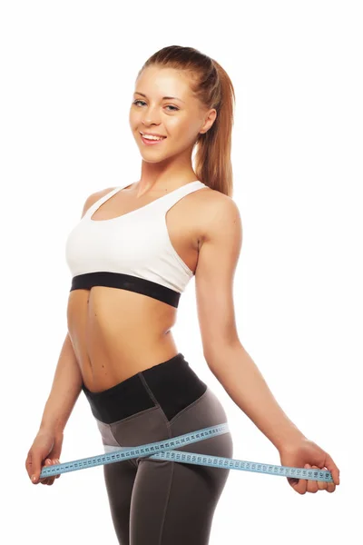 Close-up of a woman in sportswear measuring her waist — Stock Photo, Image