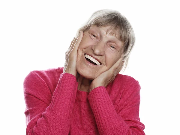 Old happy surprised woman over white background, lifestyle concept — Stock Photo, Image