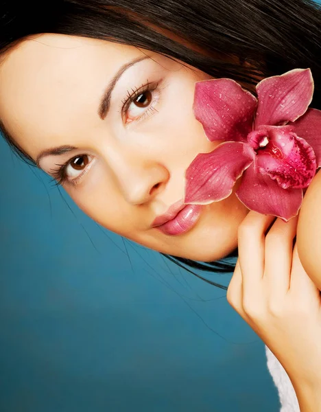 Beautiful woman with pink flower — Stock Photo, Image