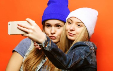 İki genç hippi kız arkadaş selfie çekiyorlar.