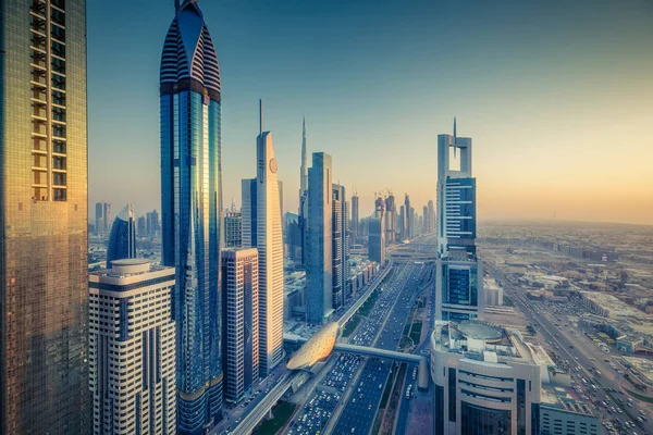 Gökdelenler ve gün batımında büyük bir modern şehrin karayolları. Dubai şehir merkezinde havadan panoramik manzara, Birleşik Arap Emirlikleri.
