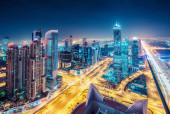 Картина, постер, плакат, фотообои "spectacular urban skyline with colourful city illuminations. aerial view on highways and skyscrapers of dubai, united arab emirates.", артикул 299978536