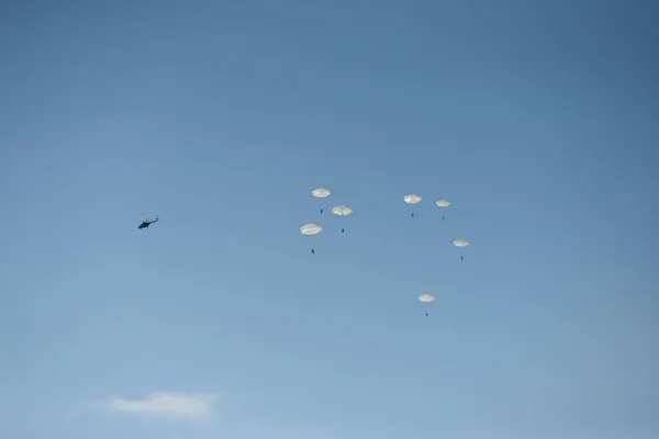 plane and jump from it parachutists in the sky