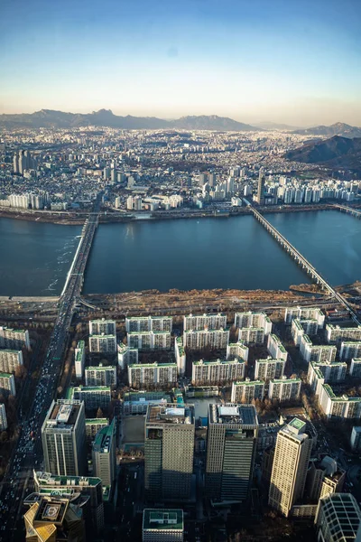 Aerial view cityscape of Seoul, South Korea. Aerial View Lotte tower at Jamsil. View of Seoul with river and mountain. Seoul downtown city skyline, Aerial view of Seoul