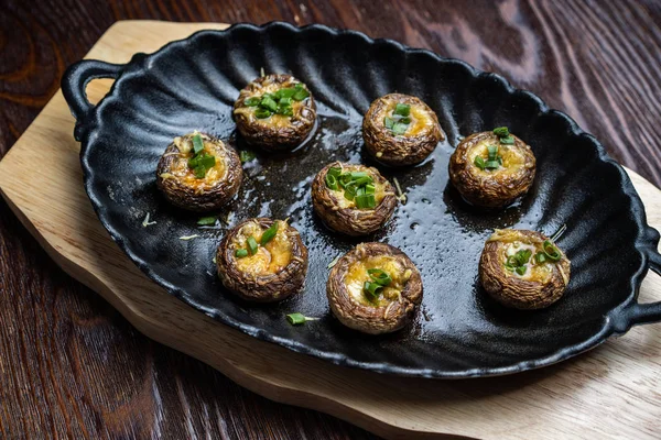 Traditional Italian Mushroom Caps stuffed with Feta as close-up in a rustic frying pan — Stock Photo, Image