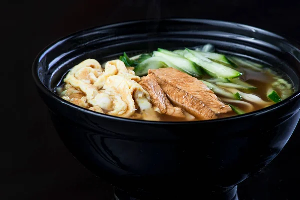 Japanese Soup With Chicken, Egg, Simeji Mushrooms and Eggplant On a Dark Background in a black plate. close up — Stock Photo, Image