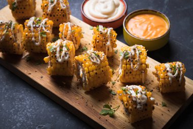 Sağlıklı parti yemeği alternatifi olarak ızgara ve baharatlı mısır dilimleri.