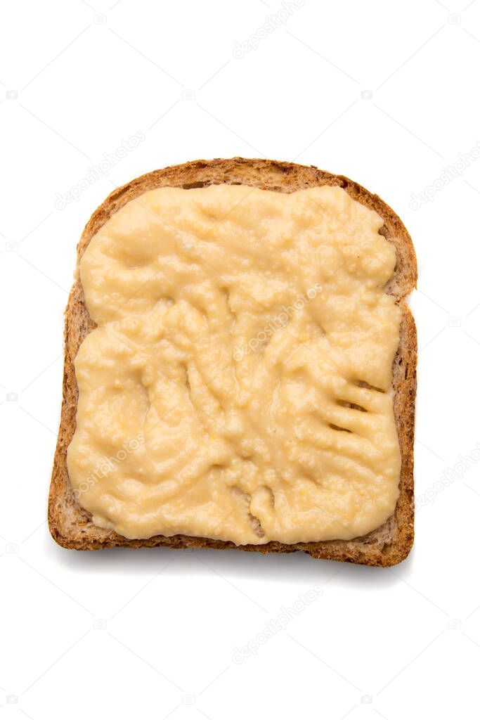 Slice of bread with spread on top isolated over white background