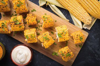 Sağlıklı parti yemeği alternatifi olarak ızgara ve baharatlı mısır dilimleri.