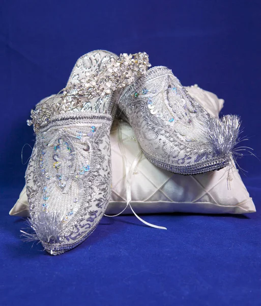 east style bride wedding shoes on a blue velvet