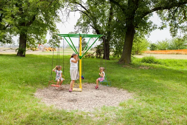 Mother Daughters Have Fun Summer Park Carousel Swing — стоковое фото