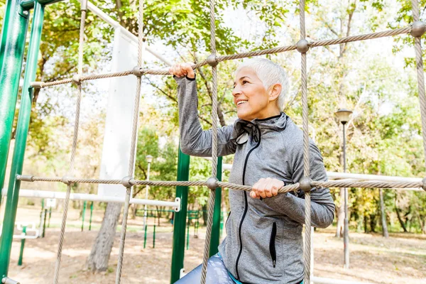 Fit Senior Woman Exercise At Outdoor Gym, Sports Clothes, Sporty Mature Female With Short Hair, Healthy Lifestyle.