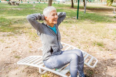 Fitness üst düzey kadın egzersiz açık spor salonu, spor giyim, sportif olgun erkek kısa saçlı, sağlıklı yaşam.