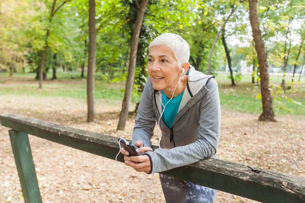 Mulher Sênior Saudável Relaxe Ouvindo Música Com Telefone Depois Jogging — Fotografia de Stock