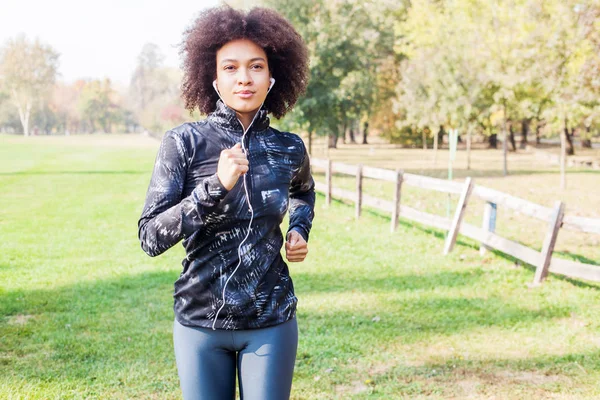 Healthy activity in park,Fitness African woman jogging at green fields in nature