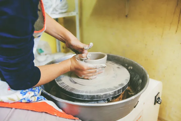 Young potter hands working with clay on pottery wheel — Stock Photo, Image