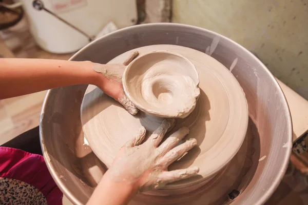 Young potter hands working with clay on pottery wheel — Stock Photo, Image