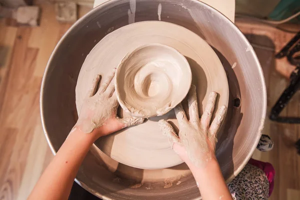 Young potter hands working with clay on pottery wheel — Stock Photo, Image