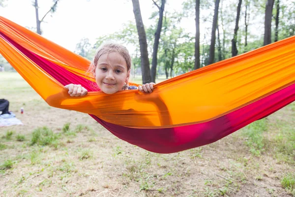 Feliz retrato de niña relajarse en la hamaca en el bosque — Foto de Stock