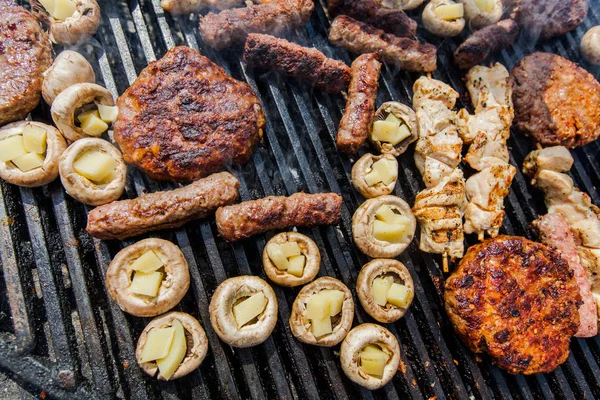 Assortment of grilled meat and filled white champignon on barbecue BBQ party — Stock Photo, Image