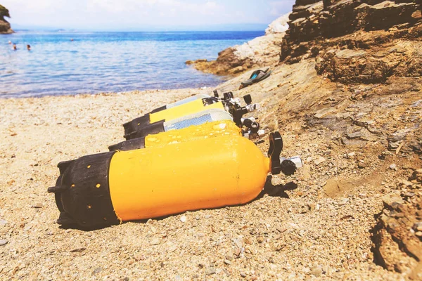 Scuba diving compressed air tanks on sand beach