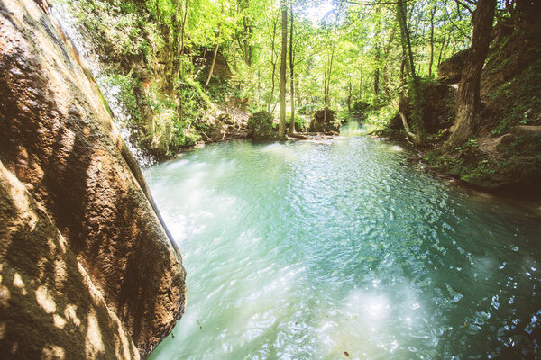 Scenic View Of Waterfall In Forest On Summer Day