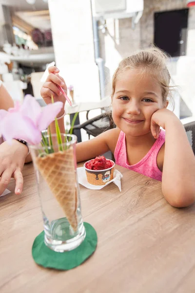 Söt liten flicka äter glass utomhus Café — Stockfoto