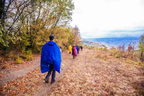 Rearview of unrecognizable people hiking on a rainy day in nature — Stock Photo, Image