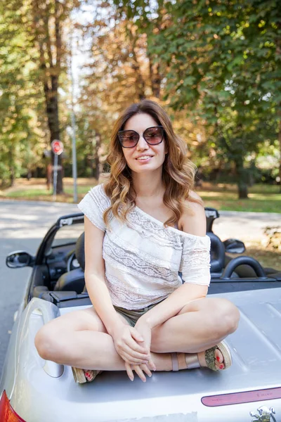 Attractive smiling woman relaxing on summer day in the park