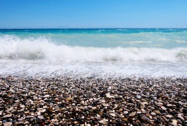 Çakıl taşı kıyısı ve deniz dalgaları