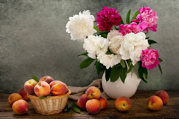 still life with a bouquet of peonies and fresh peaches