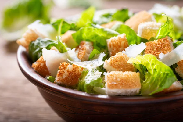 Bowl of caesar salad with cheese and croutons — Stock Image Bowl of caesar salad with cheese and croutons Stock Image
