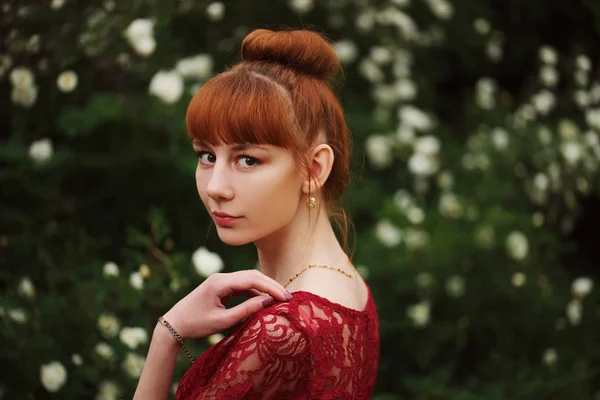 Beautiful red haired girl in park — Stock Photo, Image