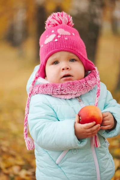 Little girl with autumn harvest in park — Stock Photo, Image