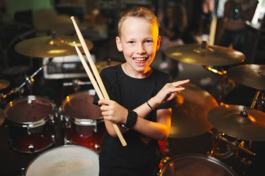 boy plays drums in recording studio clipart