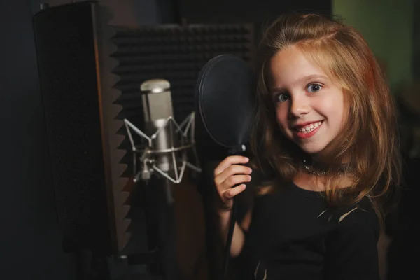 Kayıt stüdyosunda şarkı söyleyen küçük kız — Stok fotoğraf