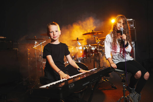 children singing and playing music in recording studio