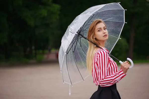 Girl with transparent umbrella in rainy weather — Stock Photo, Image