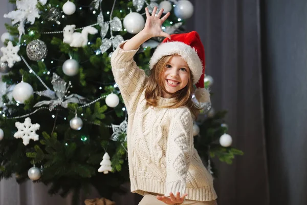 Kleines schönes Mädchen mit rotem Weihnachtsmann-Hut — Stockfoto