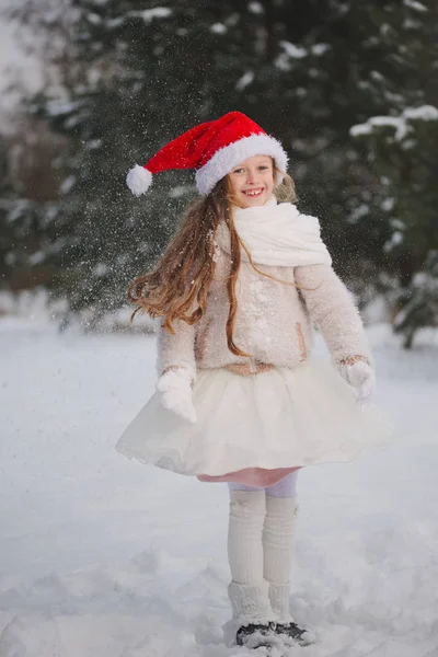 Little happy beautiful girl in winter forest — Stock Photo, Image