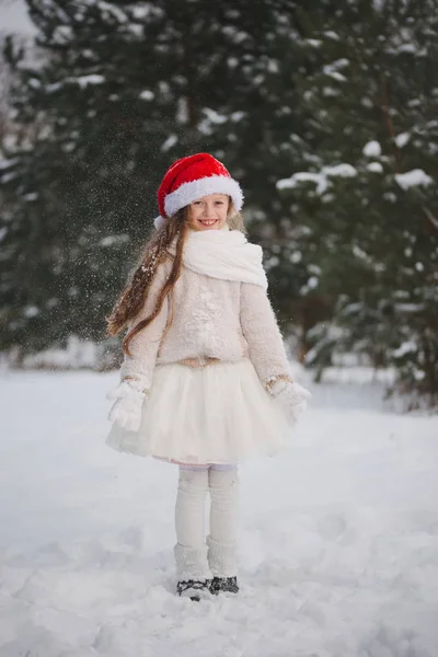 Little happy beautiful girl in winter forest — Stock Photo, Image