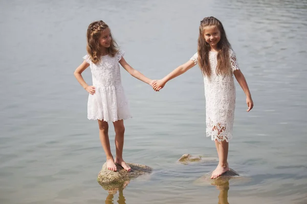 Cute happy little girls in sumer lake — Stock Photo, Image