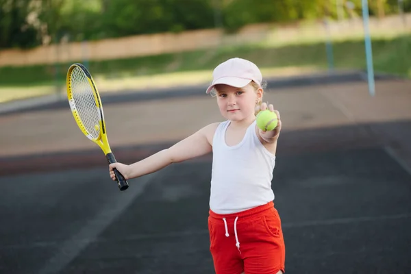 Šťastná dívka hraje tenis na dvoře venku — Stock fotografie
