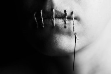 Artistic conceptual photo of a woman with stitches in her lips clipart
