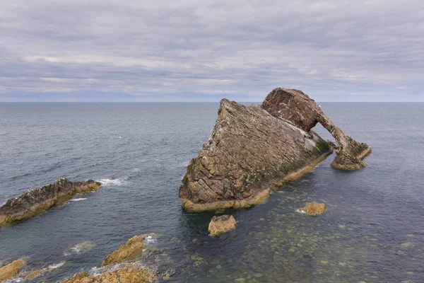 Bow-fidle Rock landscape on the coast of Scotland on cloudy afte