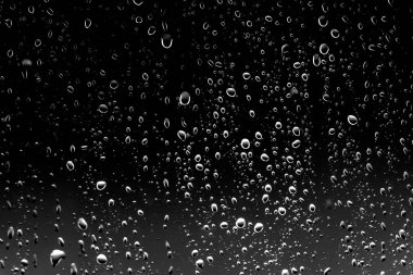 Siyah cam üzerinde yağmur damlaları