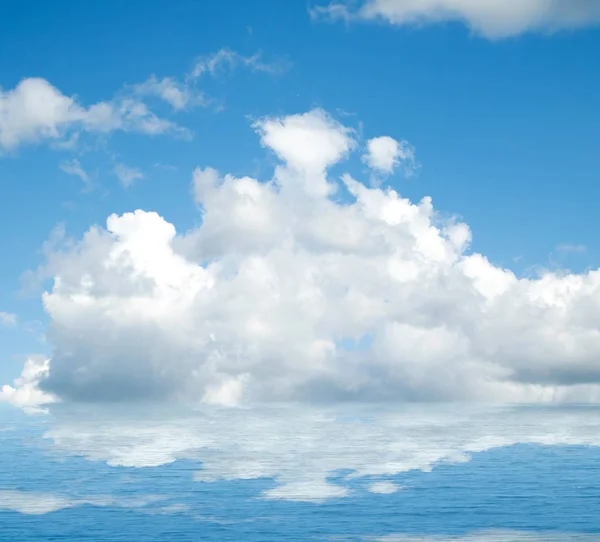 Sea clouds reflected in water